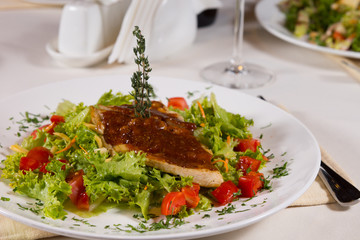 Appetizing Meaty Main Dish on Lettuce and Tomatoes