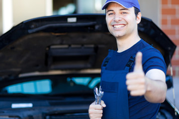 Smiling mechanic thumbs up
