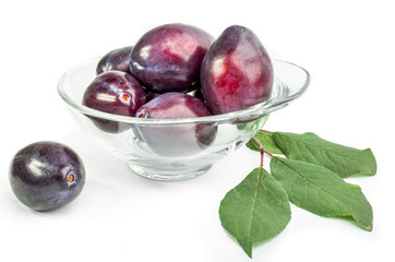 Group of plums with leaves isolated on a white background