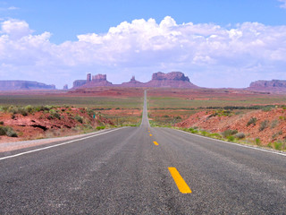 Fototapeta na wymiar Straight road in Utah and Arizona, Monument Valley Navajo Tribal