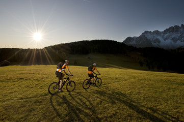Fototapeta premium two mountainbikers in her shadow - mountainbike