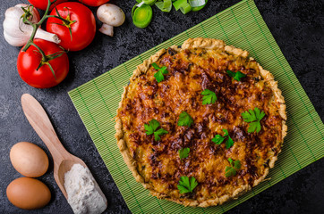 Home French quiche stuffed with mushrooms, tomato and leek