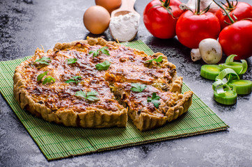 Home French quiche stuffed with mushrooms, tomato and leek