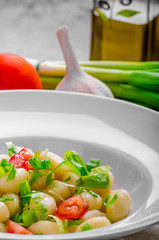 Vegetarian gnocchi with spring onions and tomatoes