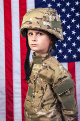 Young boy dressed like a soldier with American flag