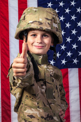 Young boy dressed like a soldier with American flag