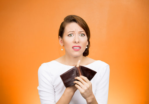 unhappy business woman showing empty wallet broke