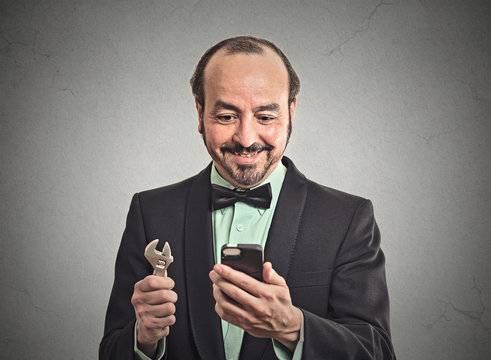 businessman looking at smartphone holding business tool