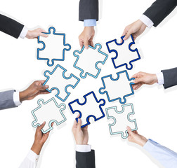 Business People Hands Holding Pieces Of Puzzle