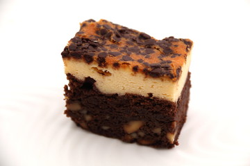 Brownie Cheese cake on a white plate.