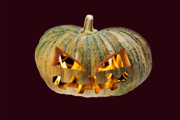 halloween pumpkin with flame inside isolated on black