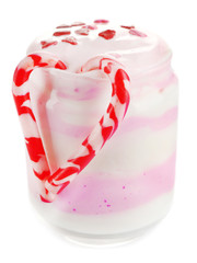 Raspberry milk dessert in glass jar, isolated on white