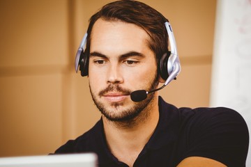 Businessman using headset in distribution warehouse