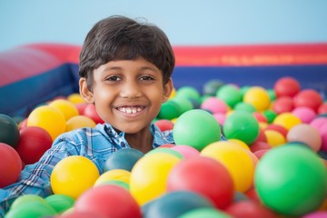Fototapeta na wymiar Cute boy smiling in ball pool