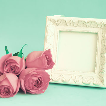 Vintage photo frame and red roses
