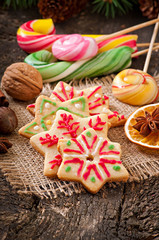 Christmas gingerbread cookies and lollipops on old wooden backgr