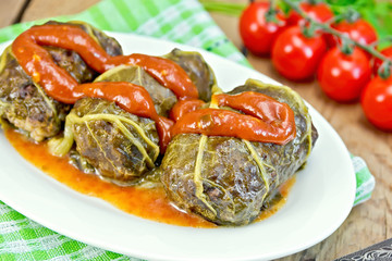 Rhubarb leaves stuffed in plate with sauce on board