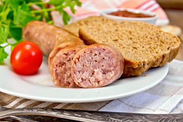Sausages pork grilled in plate with bread on napkin