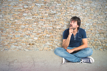 Man thinking over textured background