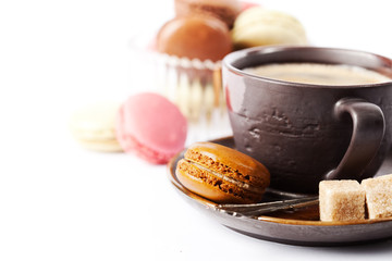 Cup of coffee and macaroons on white background, toned