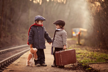 Two boys on a railway station, waiting for the train