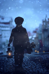 Silhouette of boy, standing on stairs, holding lantern and teddy