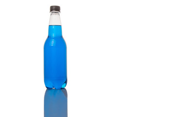 Blue colored soda drinks in bottles over white background 