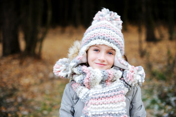 Portrait of adorable girl outdoor in winter park