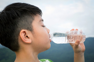 Boy drinking mineral water