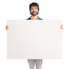Businessman with empty placard over idolated white background
