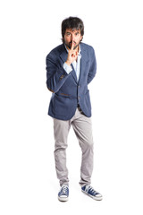 Fototapeta premium Man making silence gesture over isolated white background