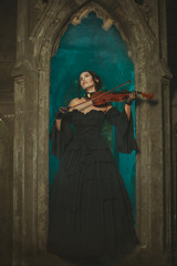 Secret medieval girl playing the violin at night.