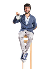 Man holding a clock over white background