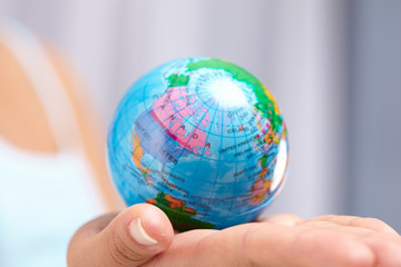 woman's hand with globe