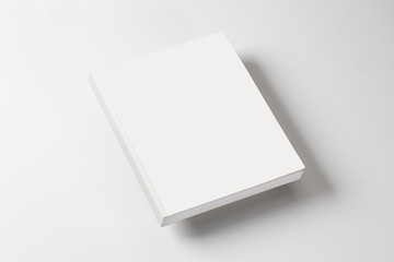 whitte book on a white table with natural shadow