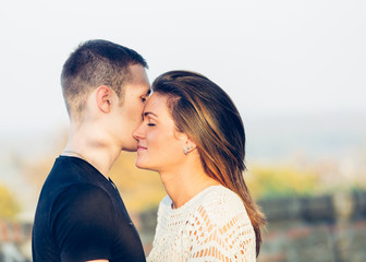 Young happy couple posing outdoor. Autumn scenery.