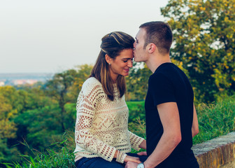 Young happy couple posing outdoor. Autumn scenery.