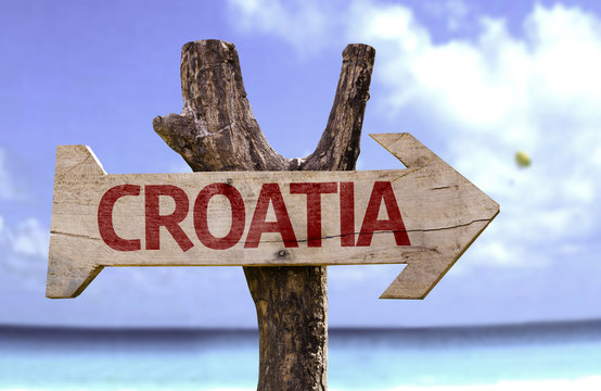 Croatia wooden sign with a beach on background