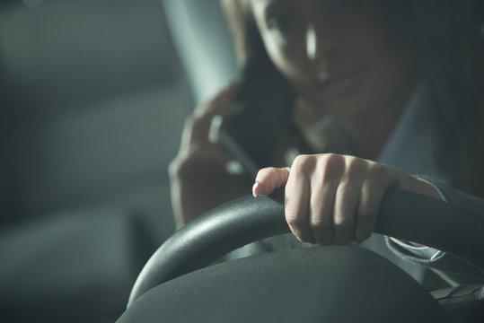 Young woman calling while driving