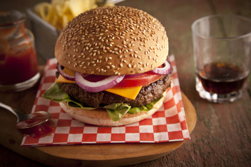 Classic deluxe cheeseburger with lettuce, onions, tomato