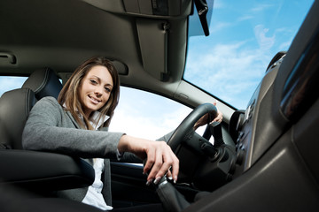 Fototapeta premium Young attractive woman driving