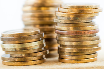 Different height yellow coin piles with white background