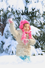 Little child playing in snow