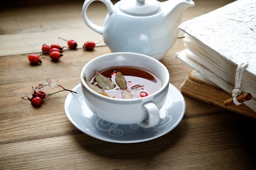 Rosehip tea with books in the background