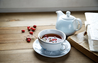 Rosehip tea with books in the background