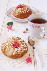 Sweet breakfast in pink: French buns and a cup of tea