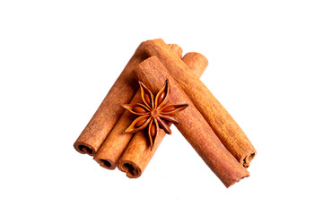 Cinnamon sticks and anise stars on white