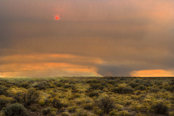 Desert area with a fire in the distance