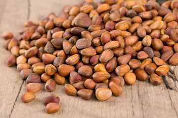 pine nuts on wooden surface