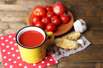 Homemade tomato juice in color mug, toasts and fresh tomatoes